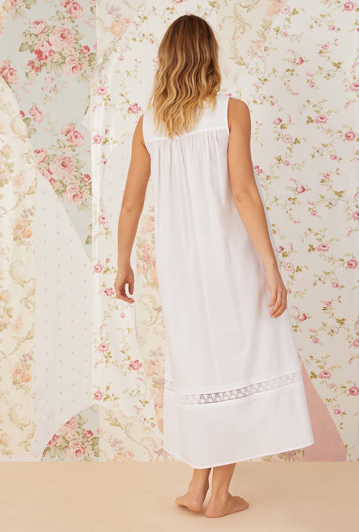 A lady wearing white sleeveless portofino ballet nightgown.