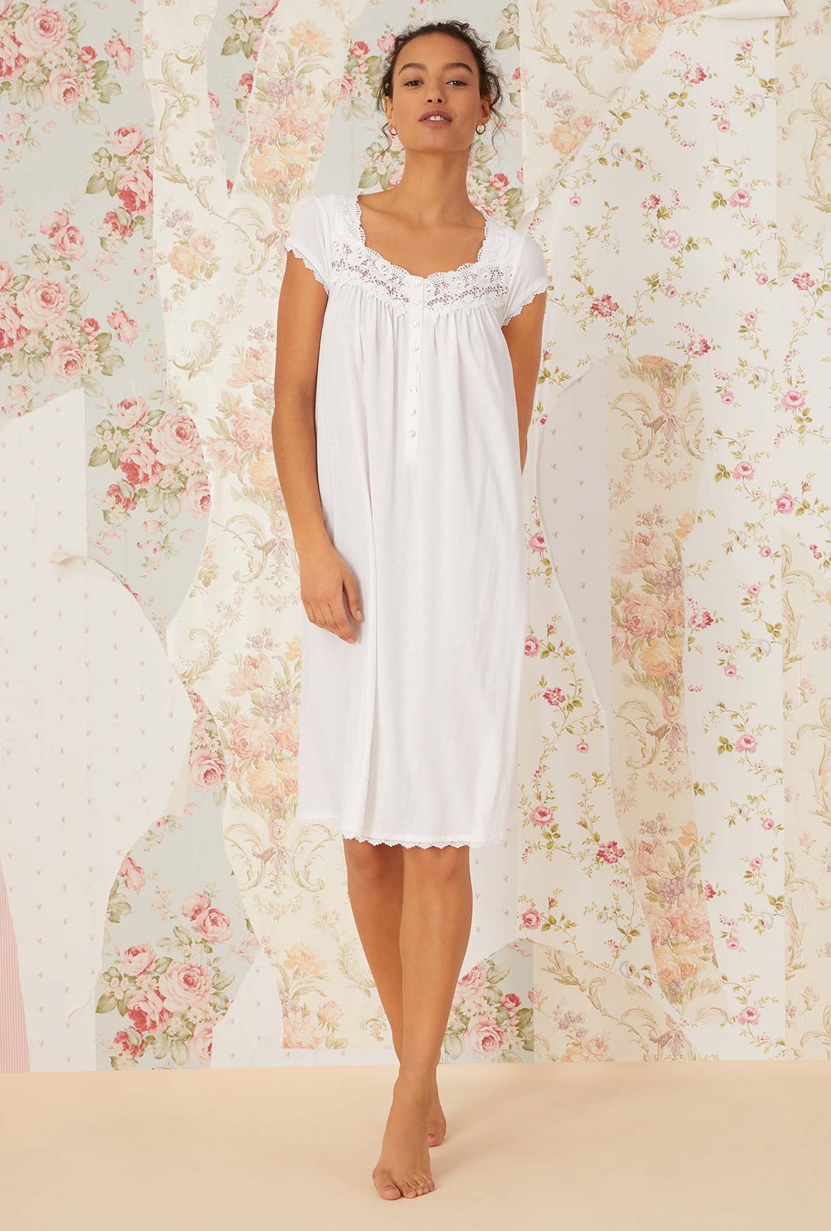 A lady wearing white villa blanca waltz knit nightgown.