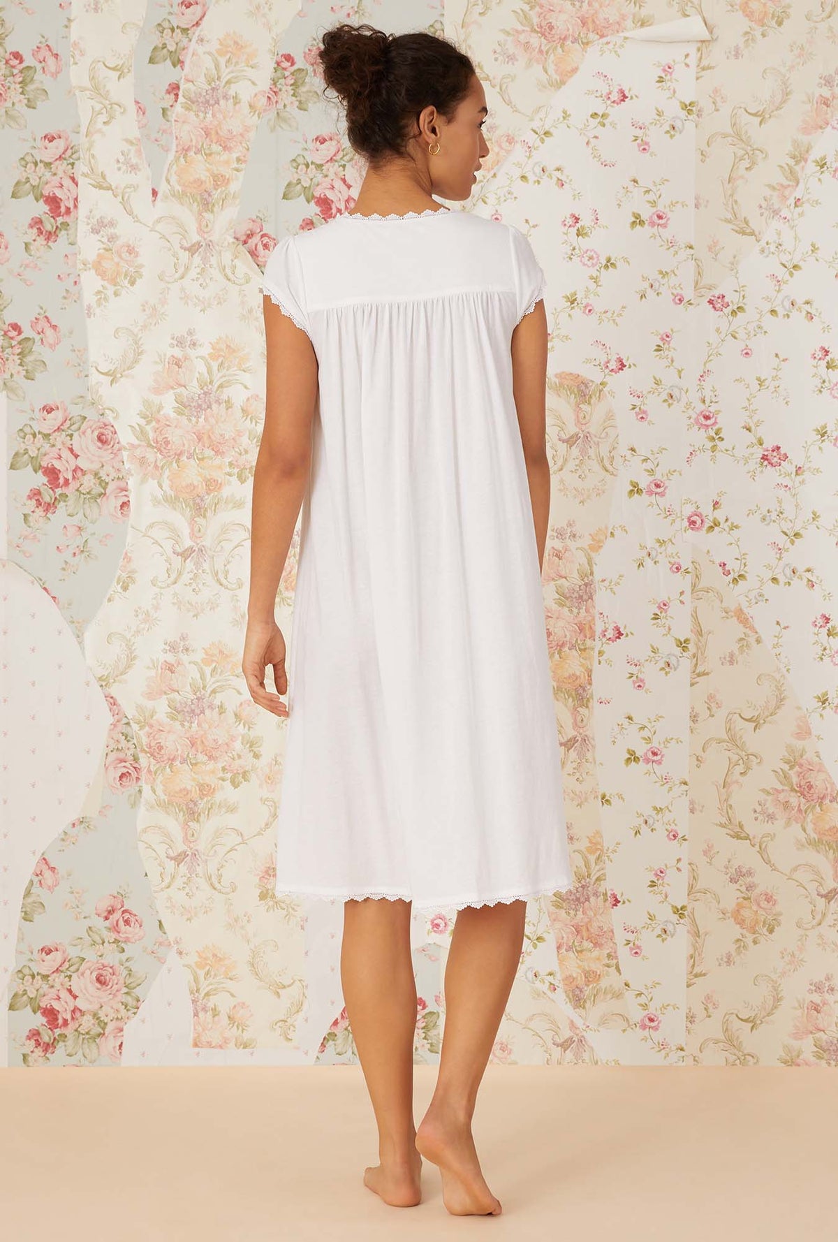 A lady wearing white villa blanca waltz knit nightgown.