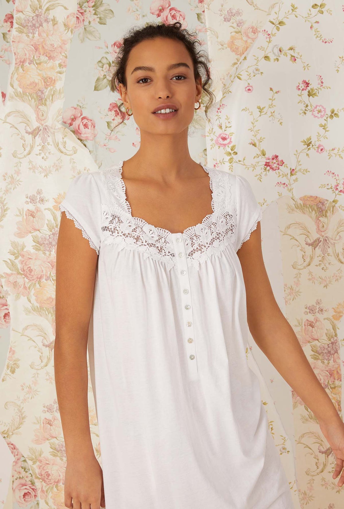 A lady wearing white villa blanca waltz knit nightgown.