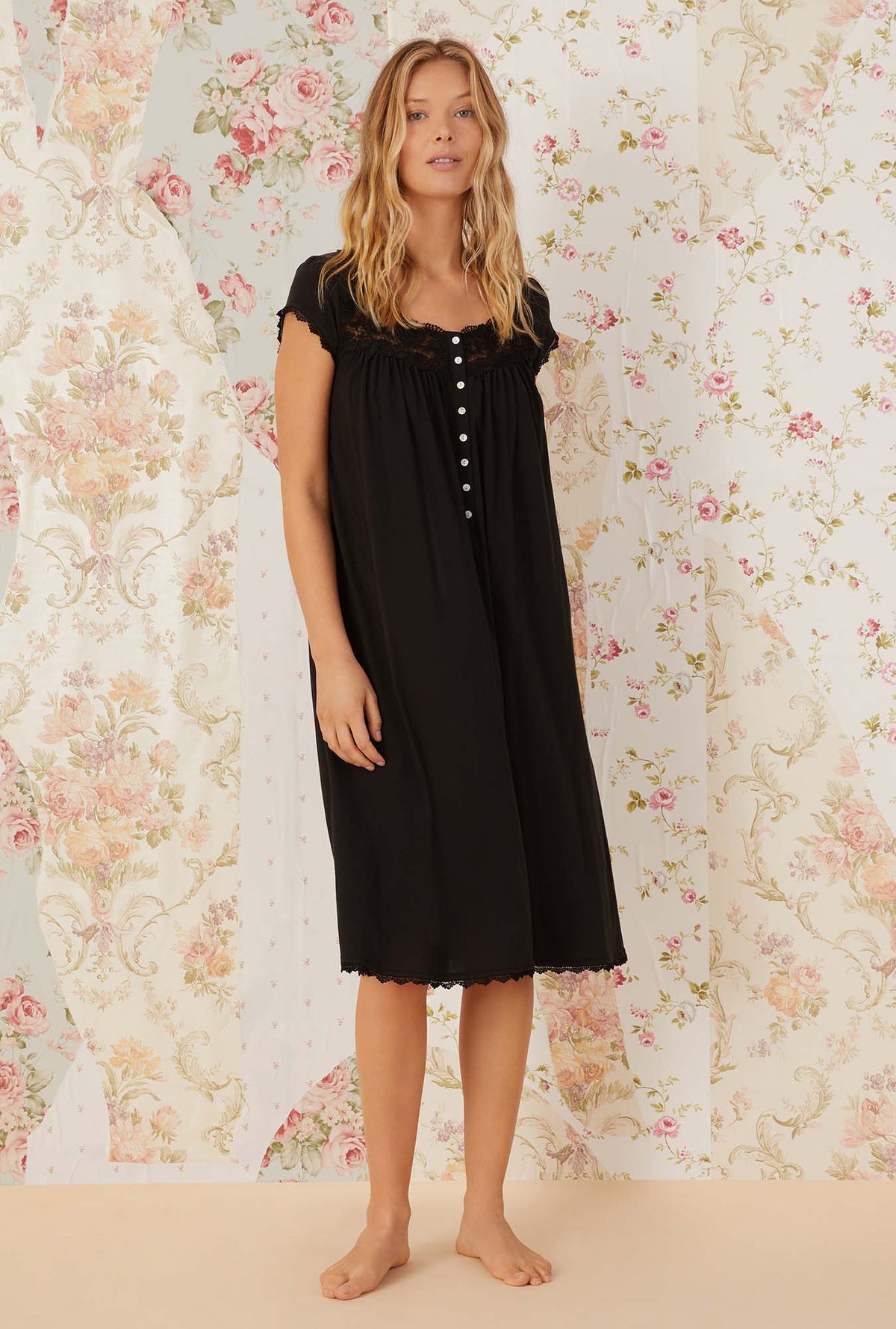 A lady wearing black villa blanca waltz knit nightgown.