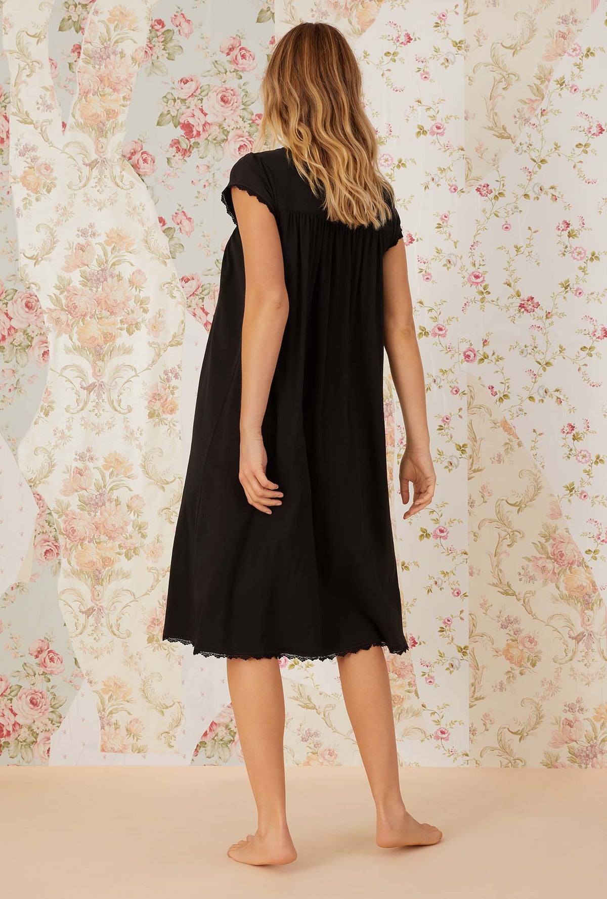 A lady wearing black villa blanca waltz knit nightgown.