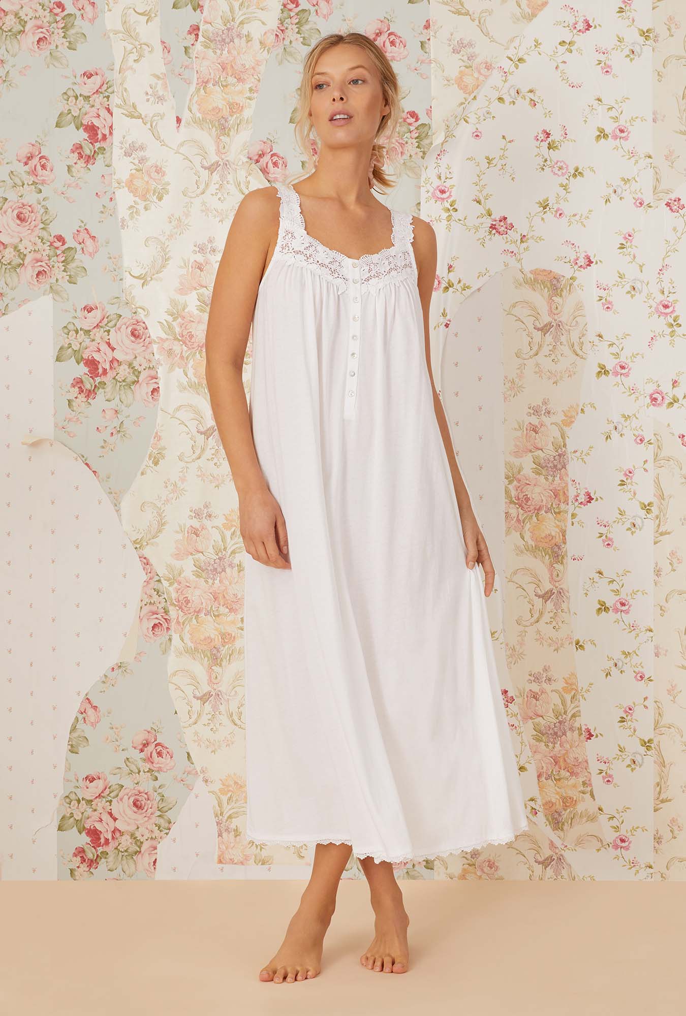 A lady wearing white sleeveless villa blanca knit ballet nightgown.