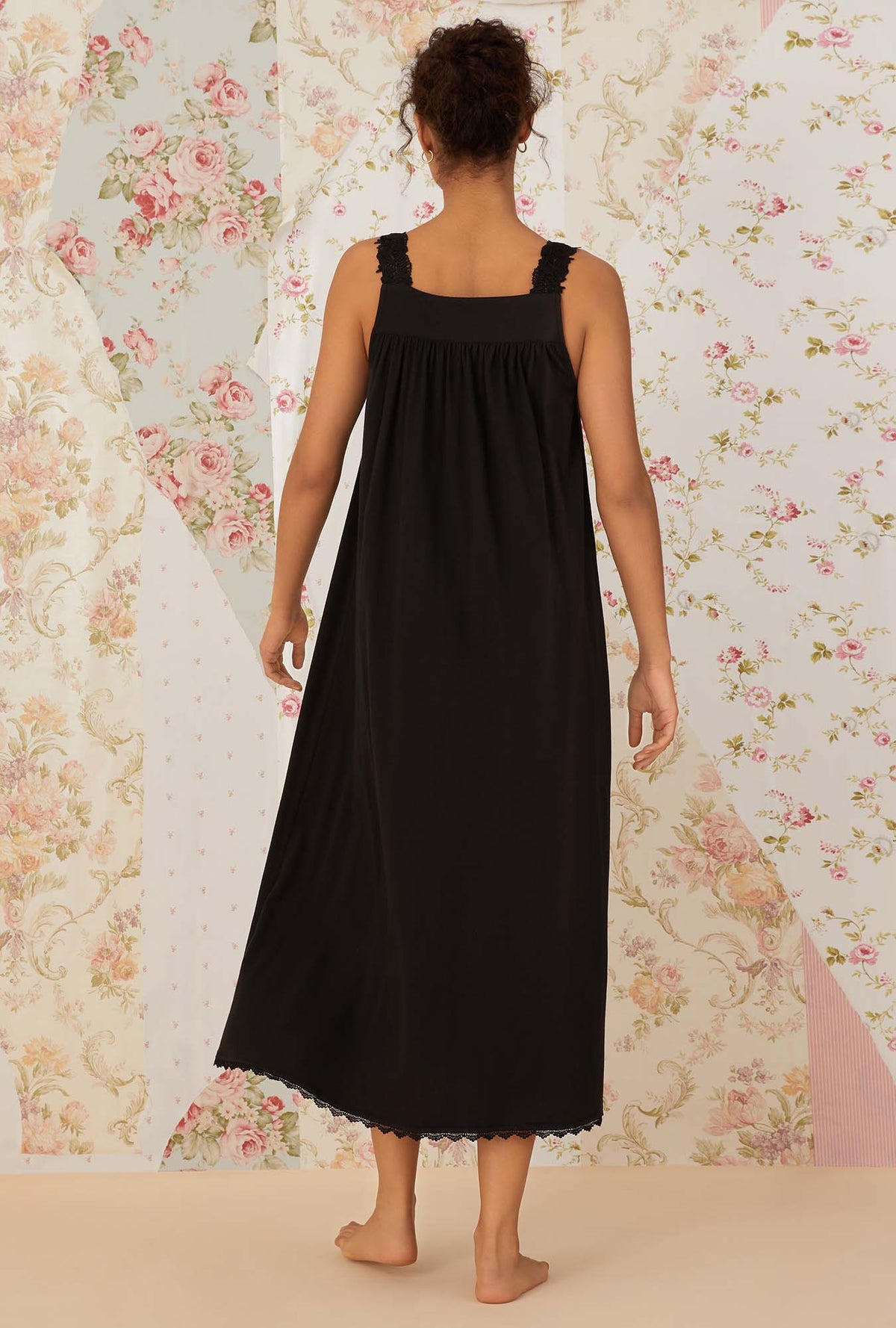 A lady wearing black sleeveless villa blanca knit ballet nightgown.