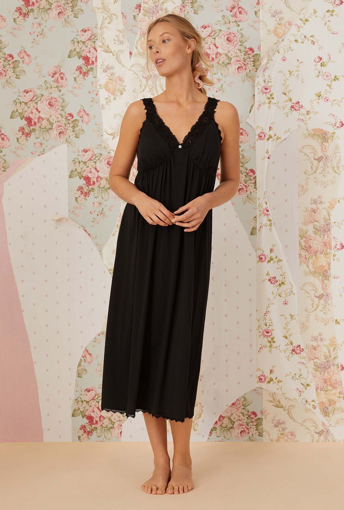 A lady wearing black sleeveless villa blanca knit nightdress.