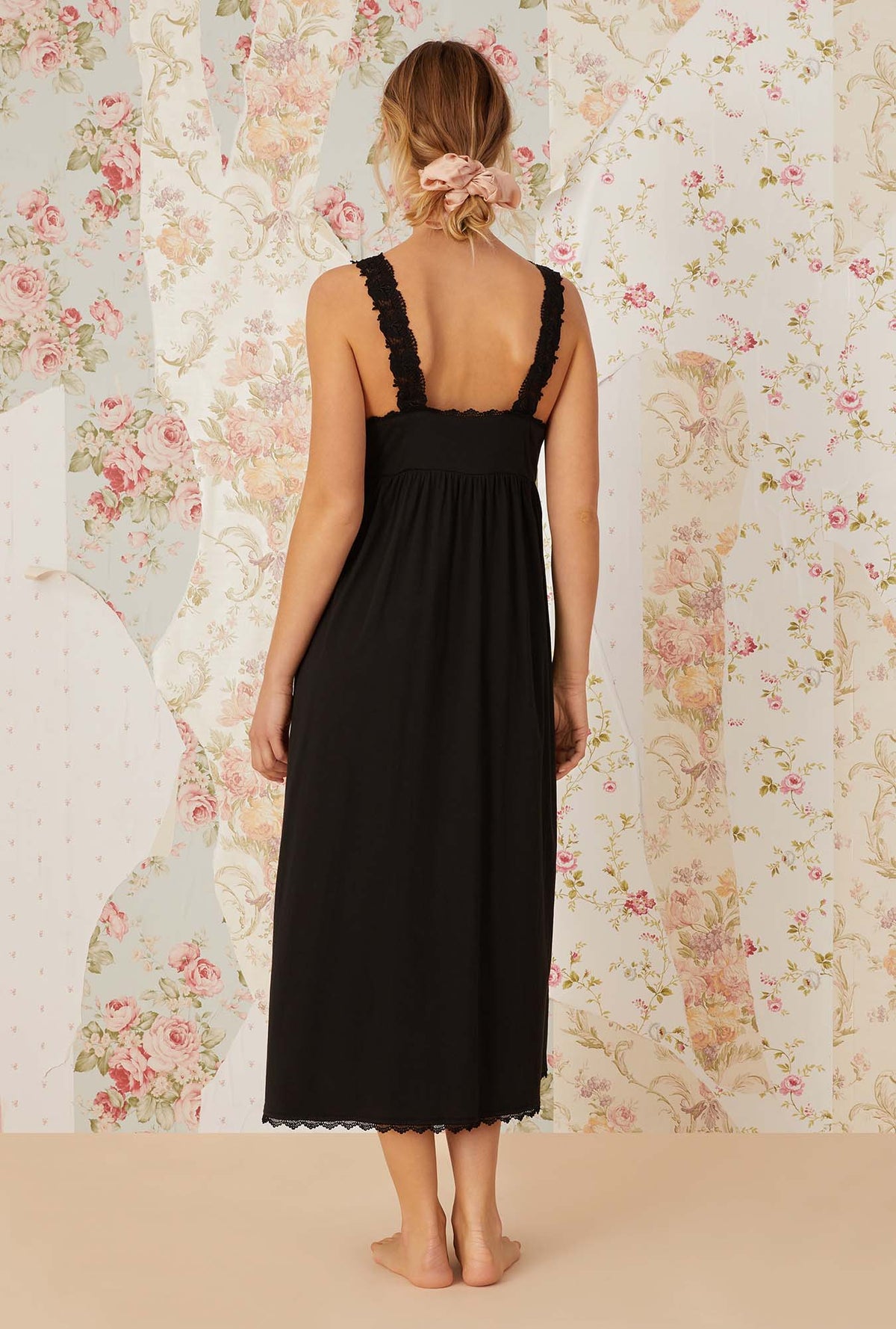 A lady wearing black sleeveless villa blanca knit nightdress.