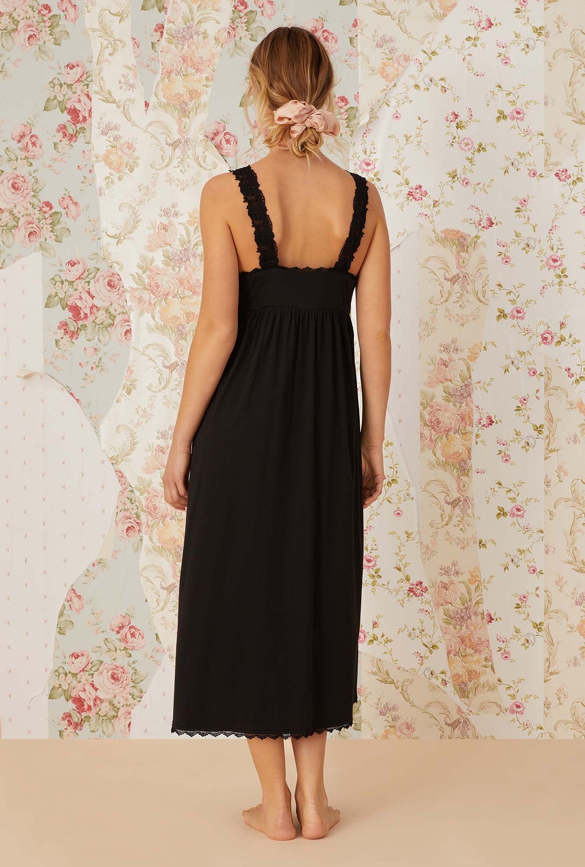 A lady wearing black sleeveless villa blanca knit nightdress.