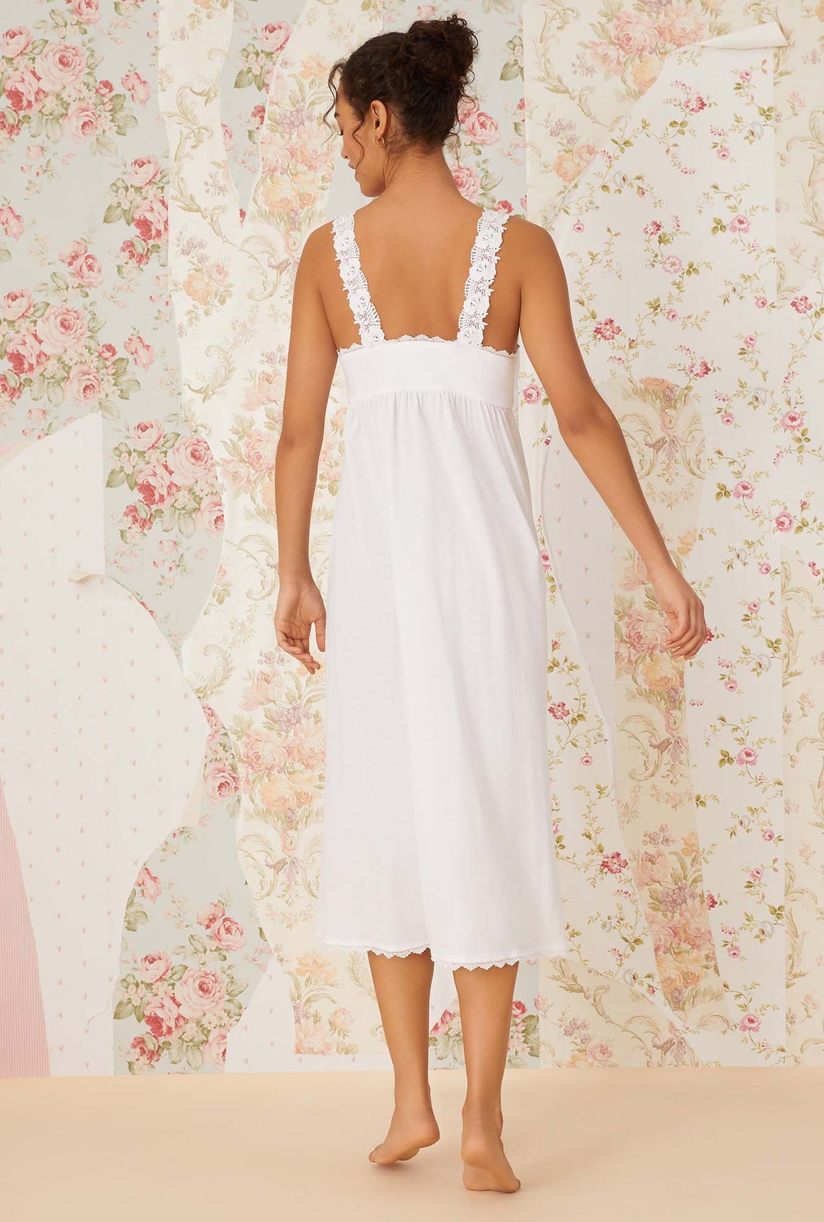 A lady wearing white sleeveless villa blanca knit nightdress.