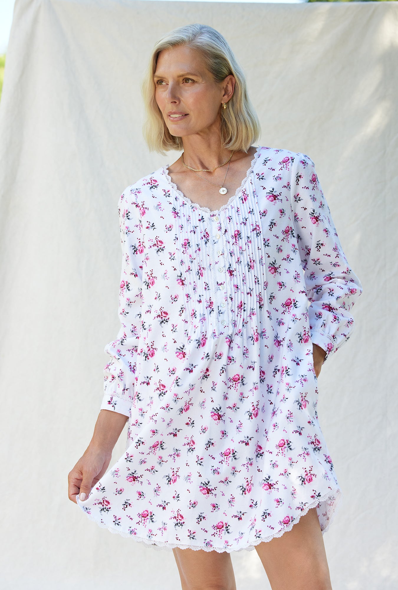 A lady wearing a berry jubilee long sleeve rayon lightweight flannel nightgown.