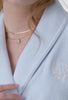 A lady wearing a terry blue long sleeve spa soft wrap robe.