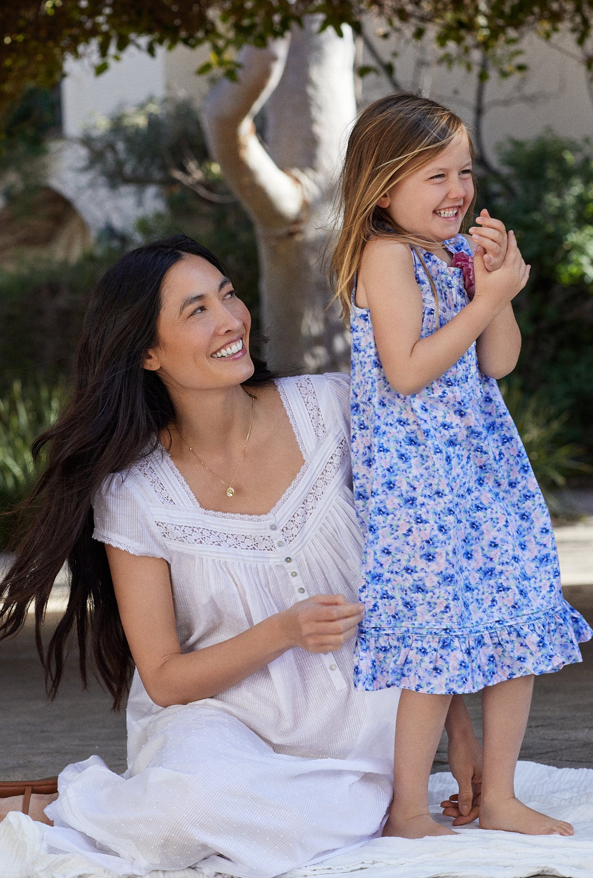 A girl wearing blue sleeveless lil eileen mother&#39;s garden girls nightgown.