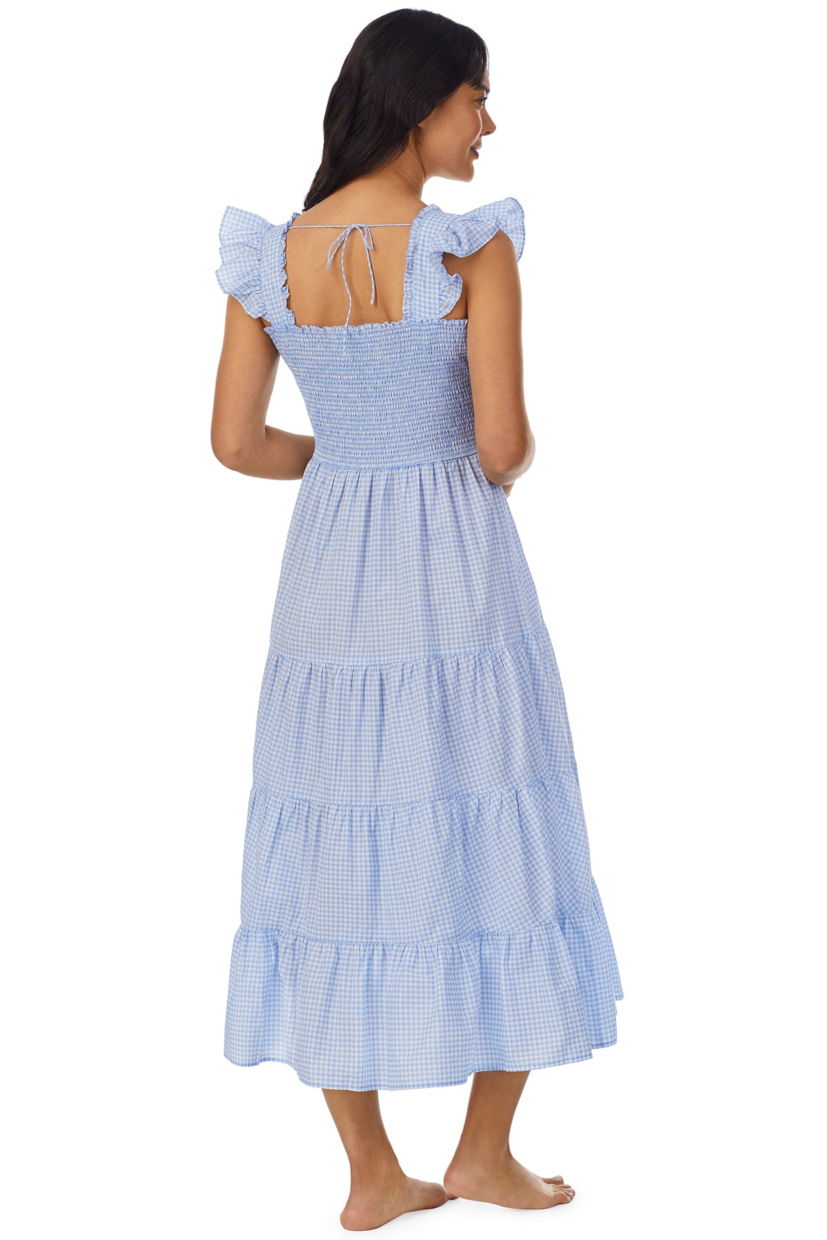 A lady wearing a blue butterfly sleeve Dress with white check pattern