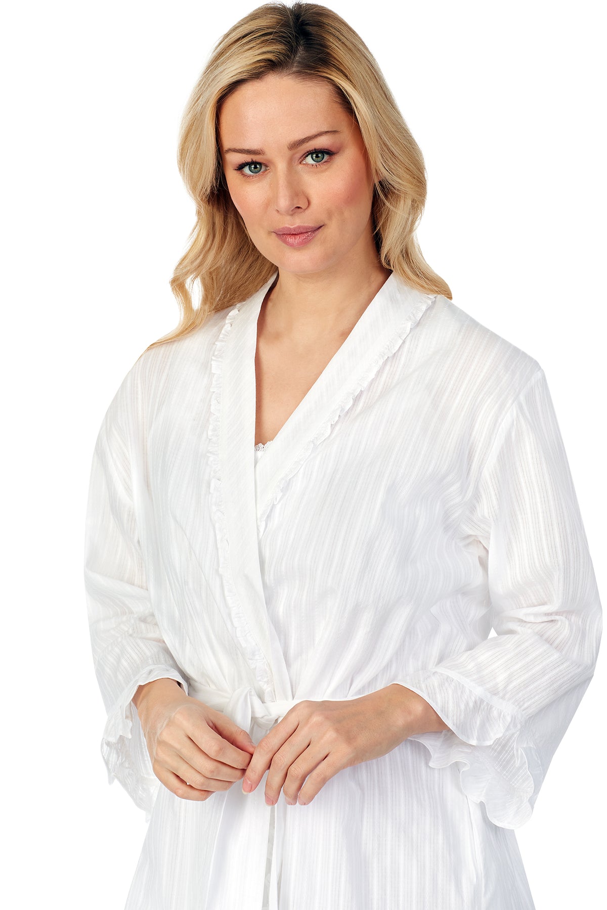 A lady wearing white short wrap robe with long sleeves.