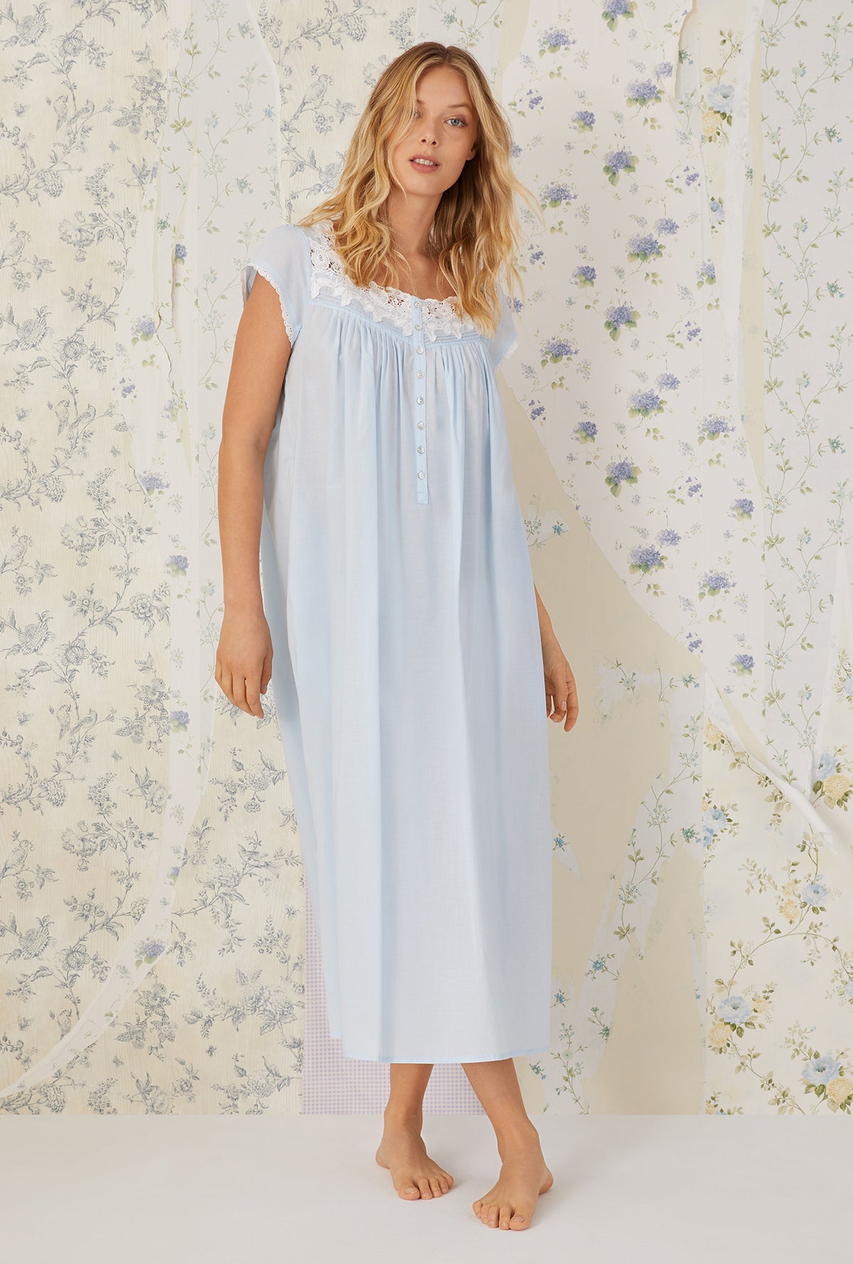 A lady wearing Florentine Lace Cap Sleeve Gown
