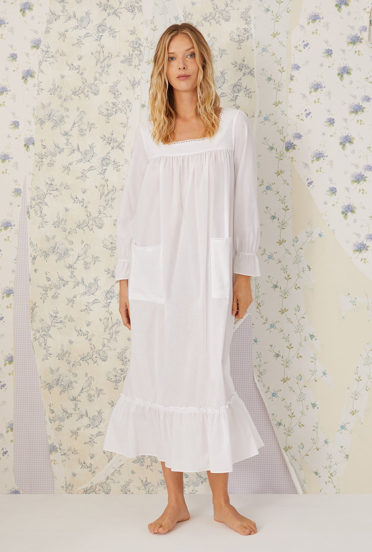 A lady wearing a white long sleeve &quot;rebecca&quot; Nightgown.
