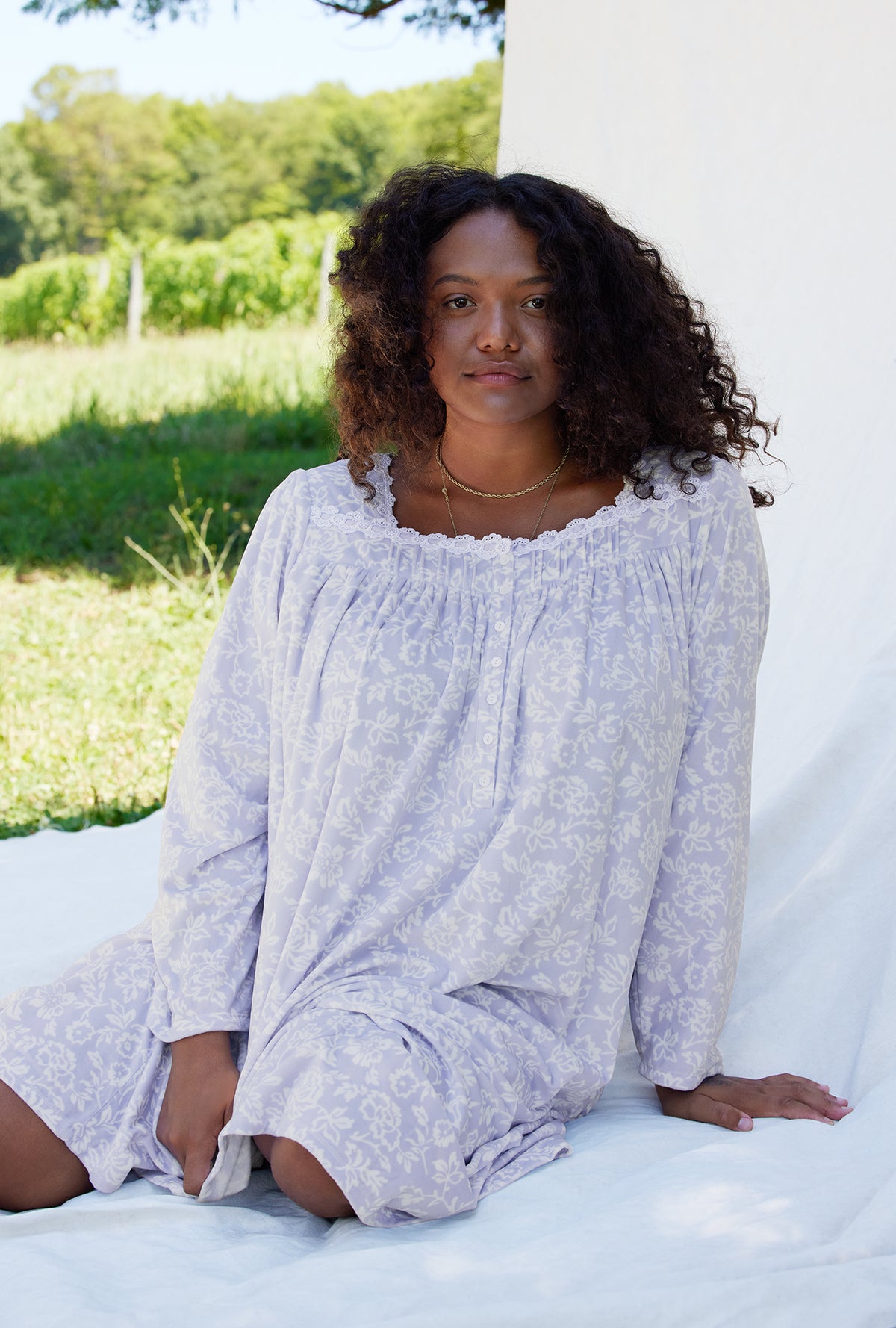 A lady wearing a dream fleece long sleeve waltz nightgown plus size.