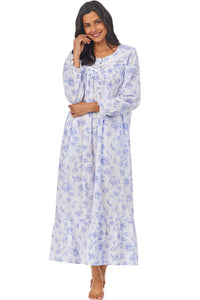 A lady wearing a white long sleeve button front robe with blue floral pattern.