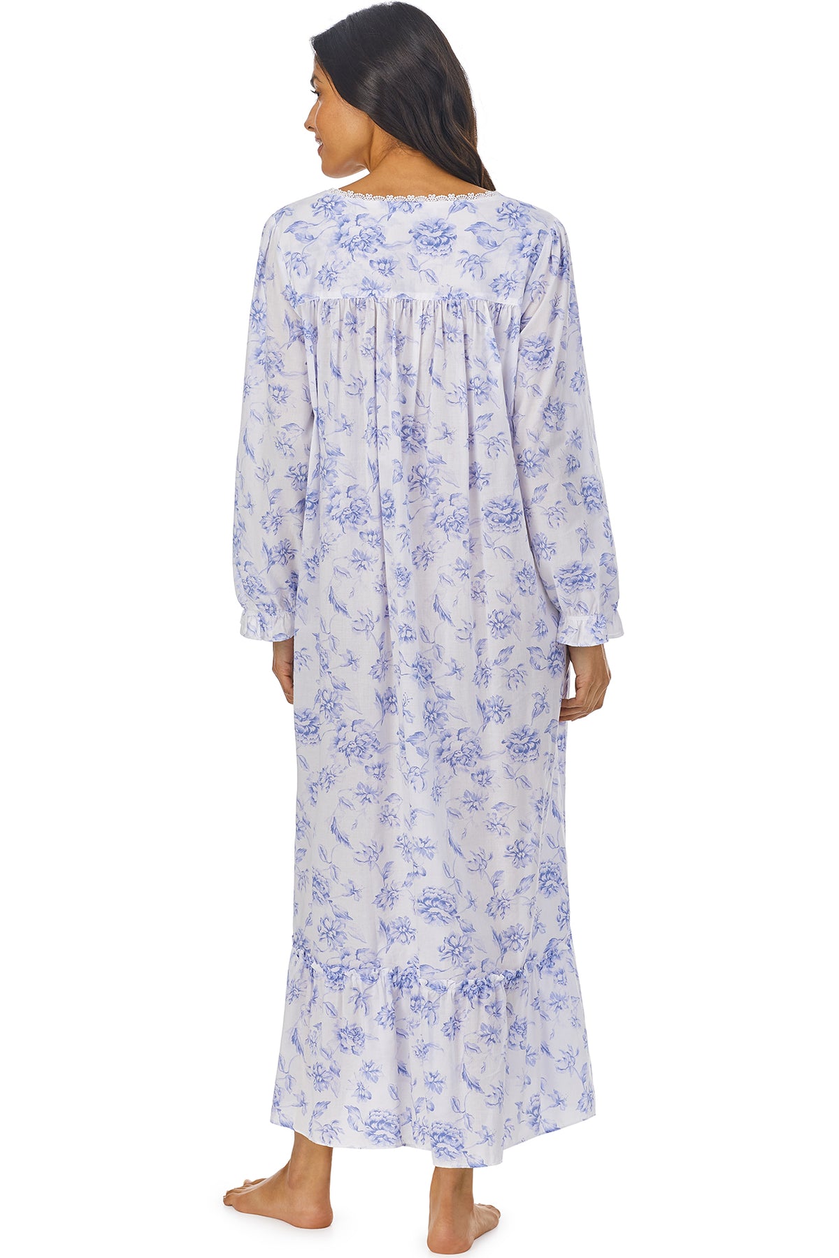 A lady wearing a white long sleeve button front robe with blue floral pattern.