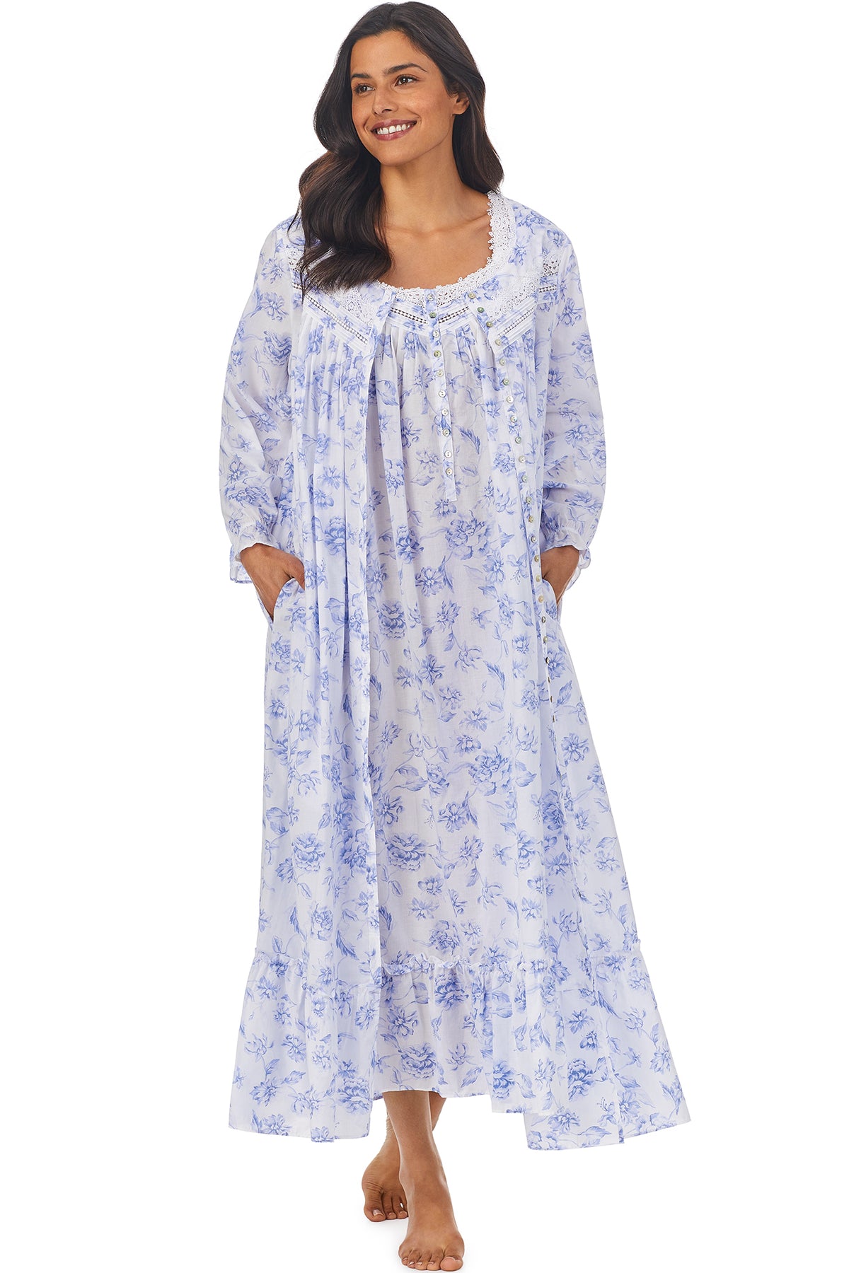 A lady wearing a white long sleeve button front robe with blue floral pattern.