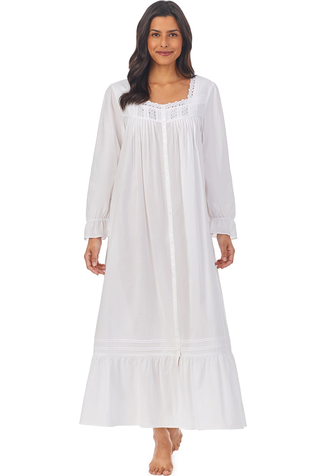 A lady wearing a white long sleeve button front robe..