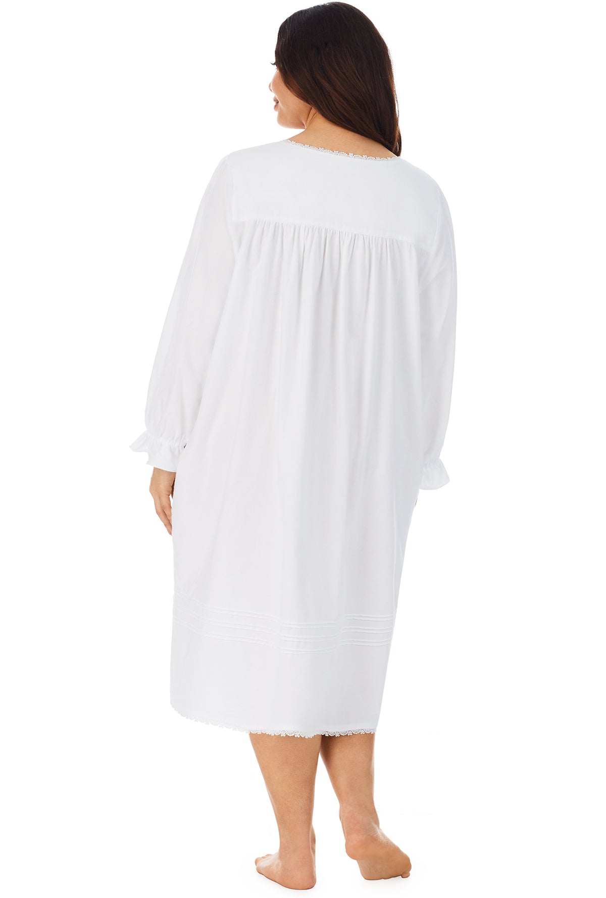 A lady wearing a white long sleeve rayon lightweight flannel waltz nightgown plus.