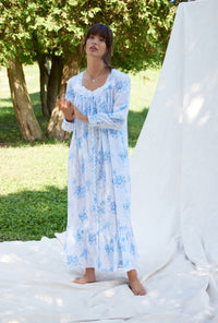 A lady wearing a pastoral floral long sleeve button front cotton robe.