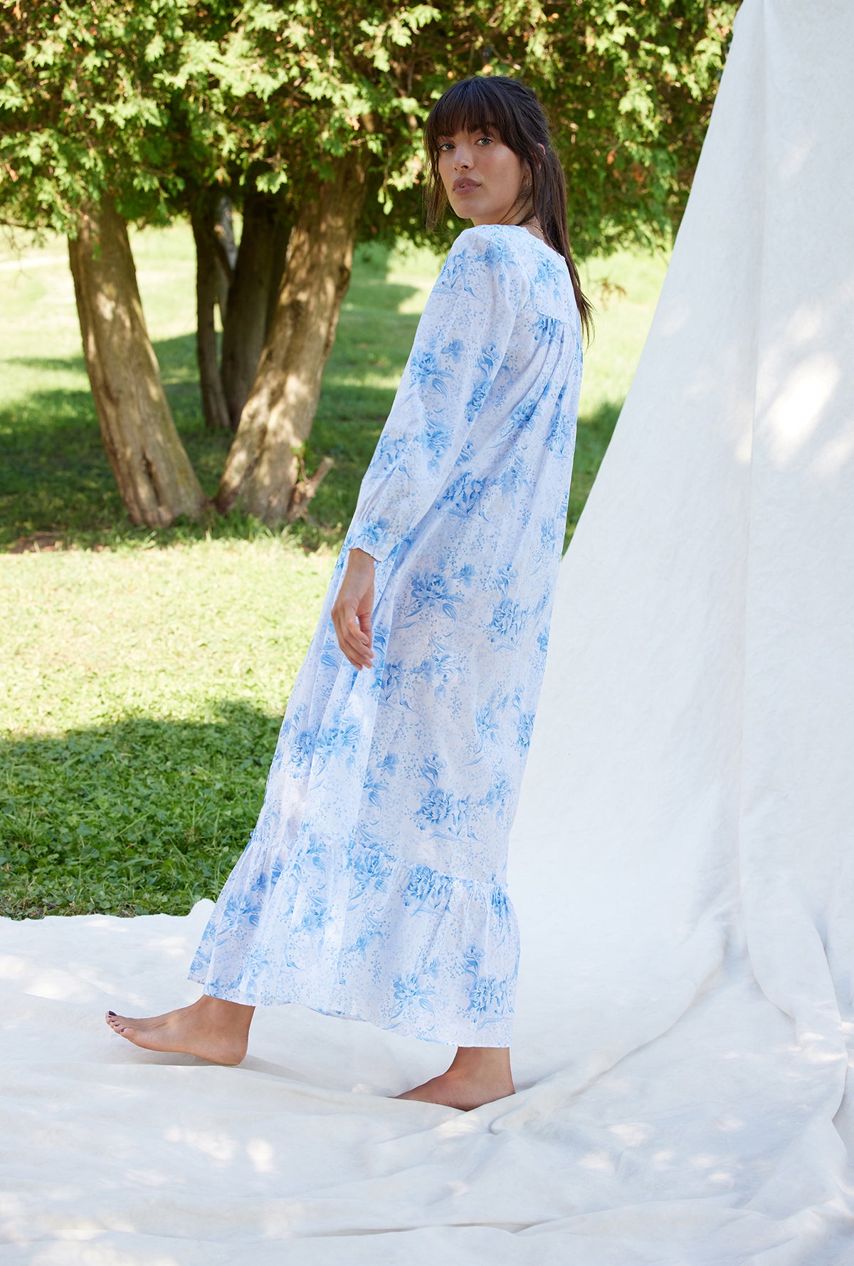 A lady wearing a pastoral floral long sleeve button front cotton robe.