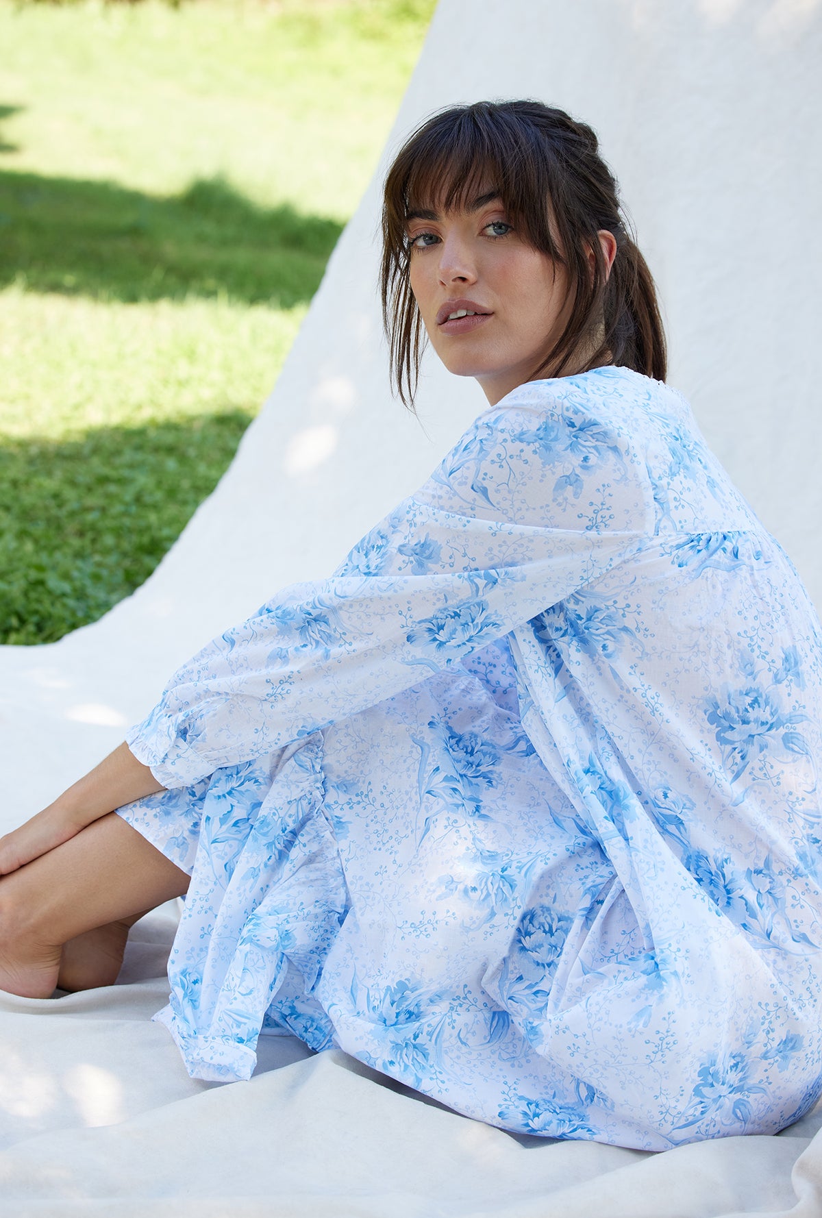 A lady wearing a pastoral floral long sleeve button front cotton robe.
