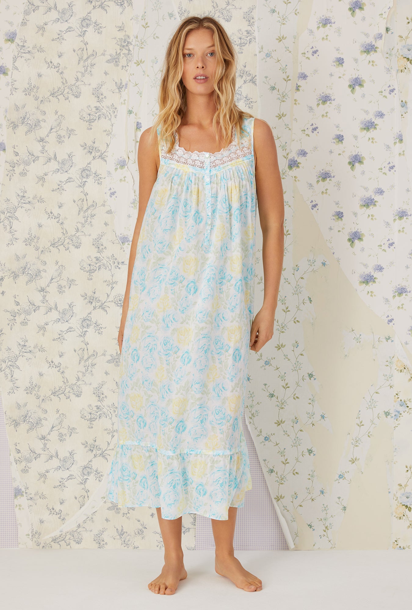 A lady wearing aqua sleeveless cotton lawn nightgown with floral pattern.