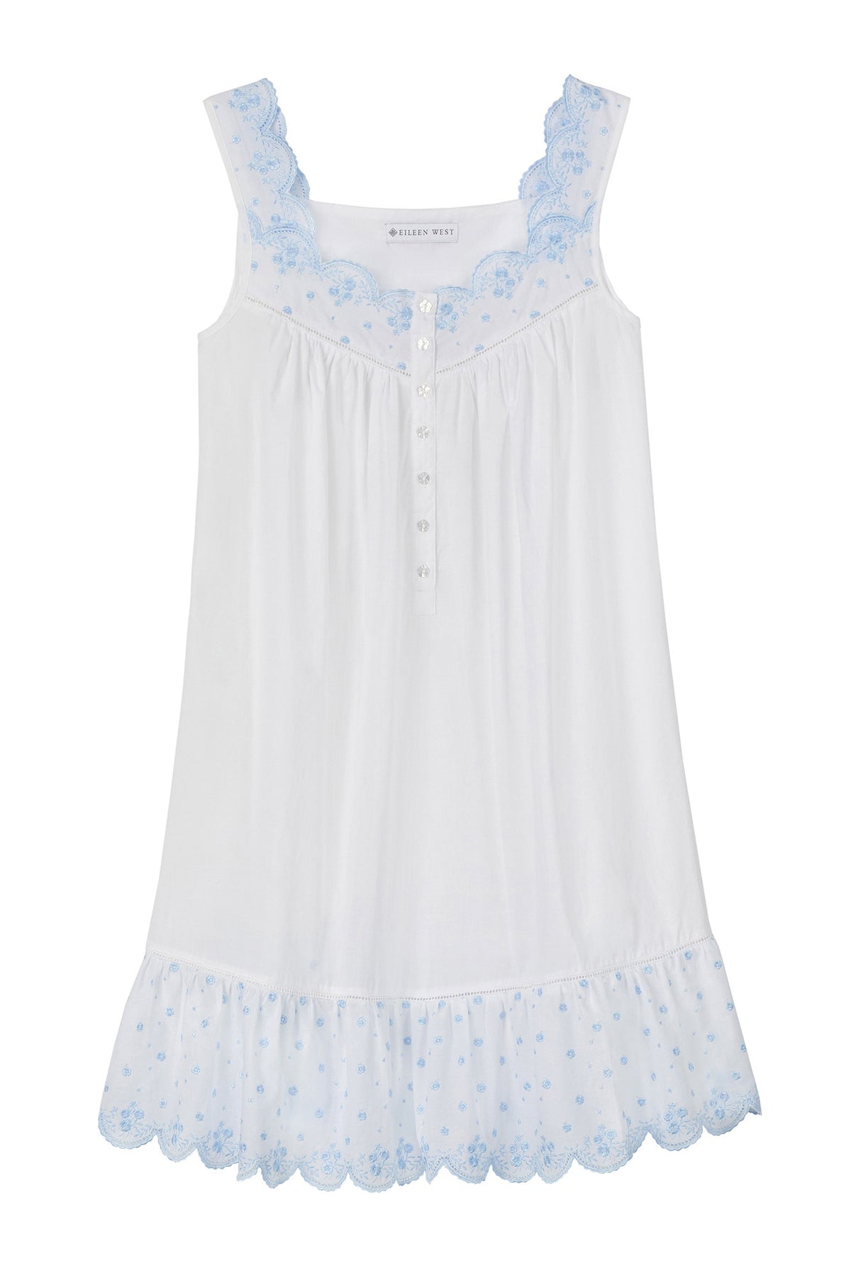 A lady wearing white sleeveless eileen scallop floral embroidery chemise.