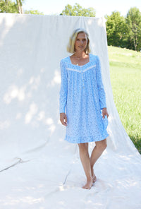 A lady wearing a blue denim floral long sleeve cotton knit short nightgown.