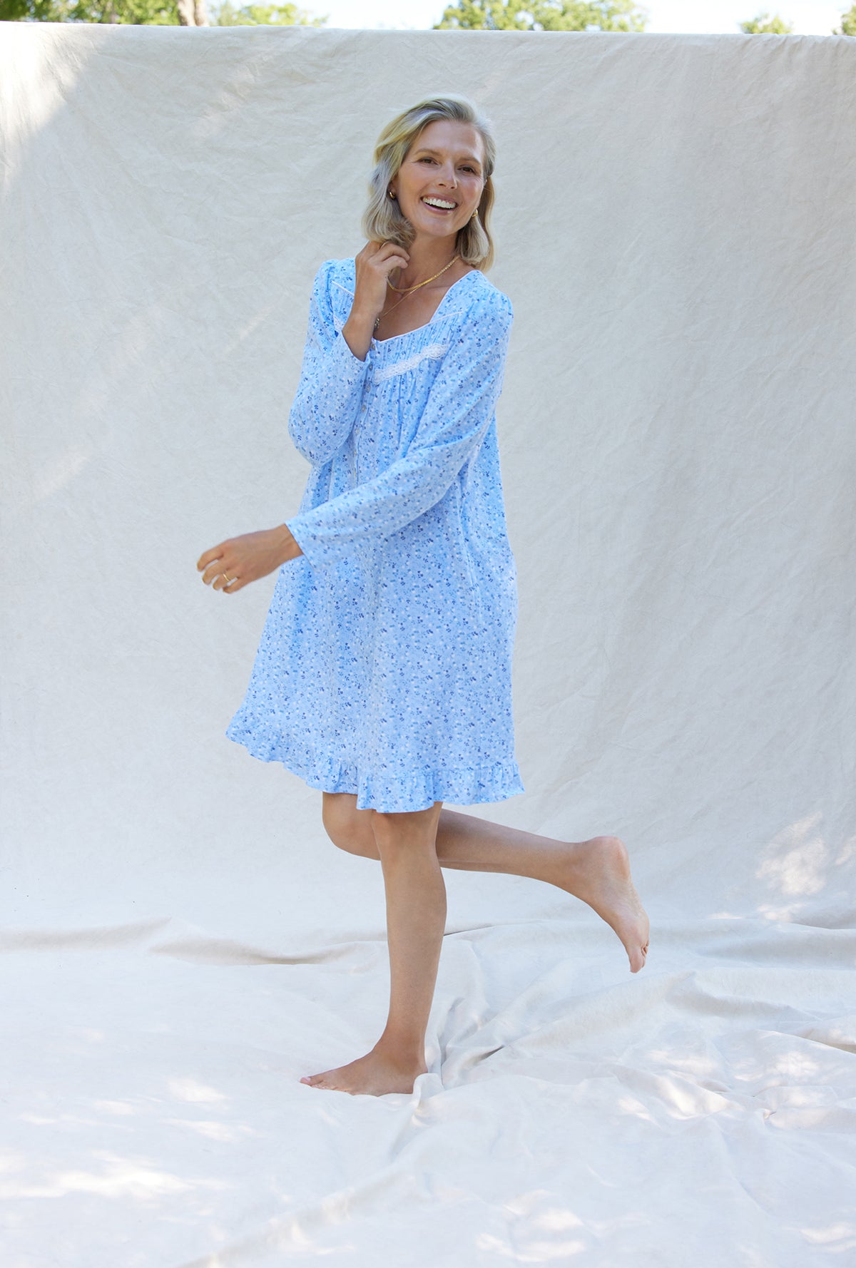 A lady wearing a blue denim floral long sleeve cotton knit short nightgown.