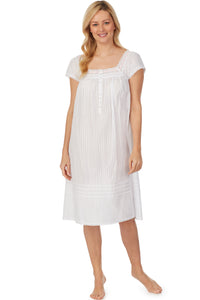 A lady wearing cap sleeve white waltz nightgown with stripe textures