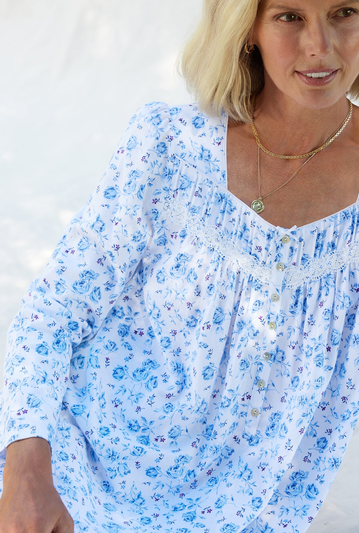 A lady wearing a rose garden floral long sleeve cotton knit short nightgown.