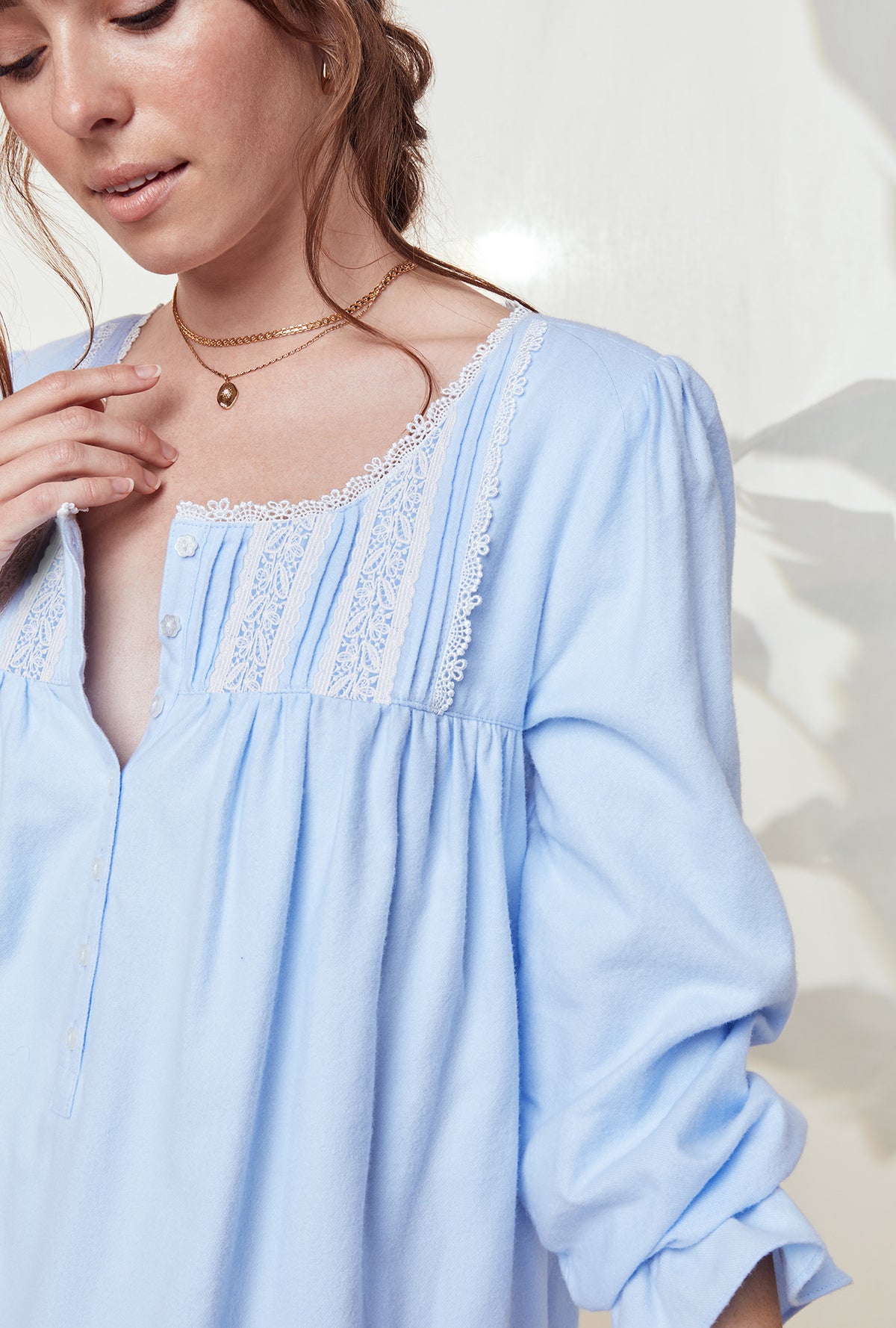 A lady wearing a heavenly blue long sleeve rayon lightweight flannel waltz nightgown.