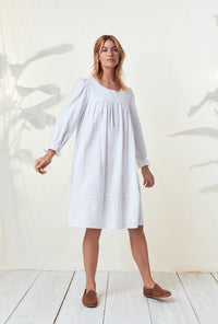 A lady wearing a white long sleeve rayon lightweight flannel waltz nightgown.