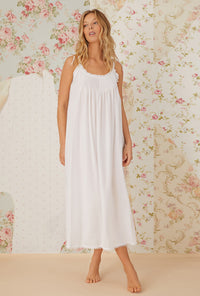 A lady wearing white sleeveless cotton nightgown with the erica.