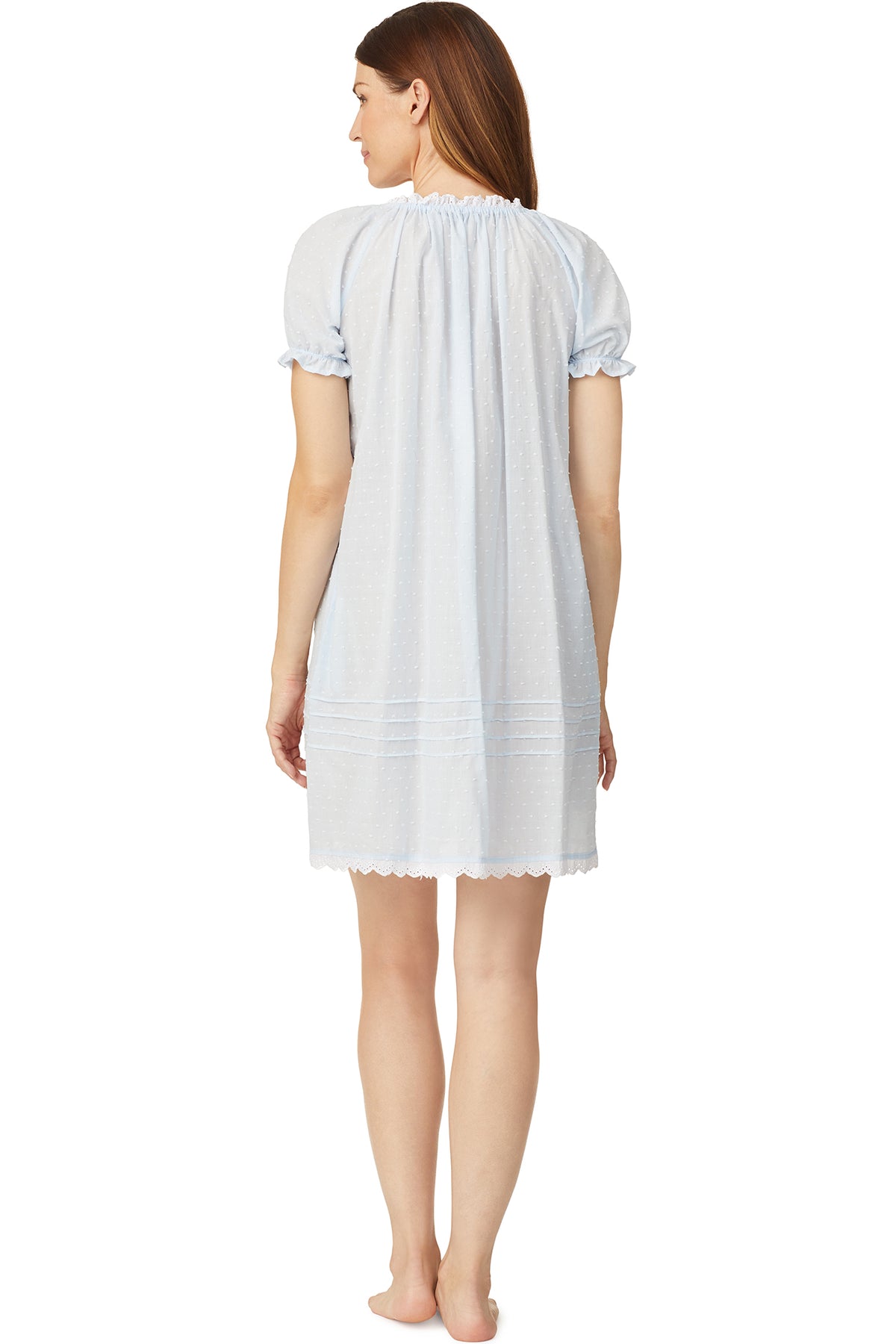 A lady wearing a blue cap sleeve short nightdress with white dot pattern.