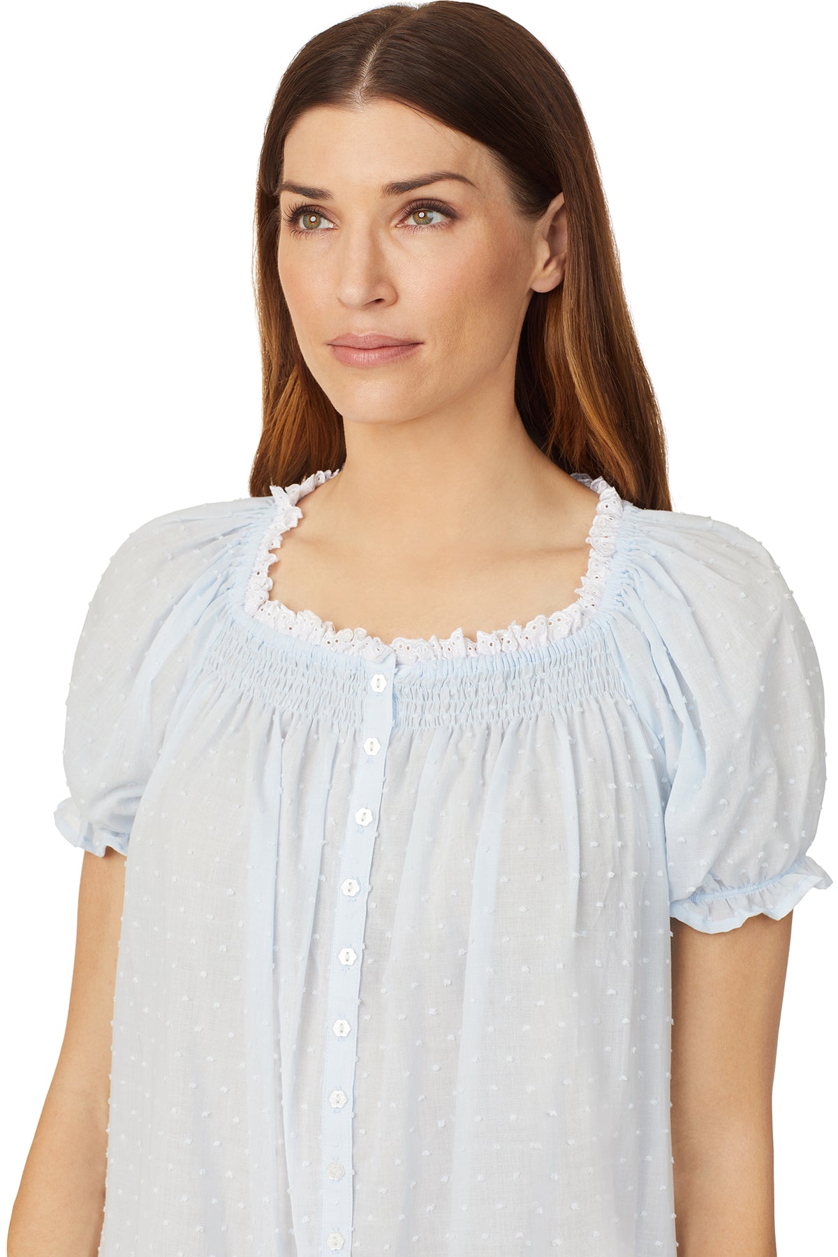 A lady wearing a blue cap sleeve short nightdress with white dot pattern.