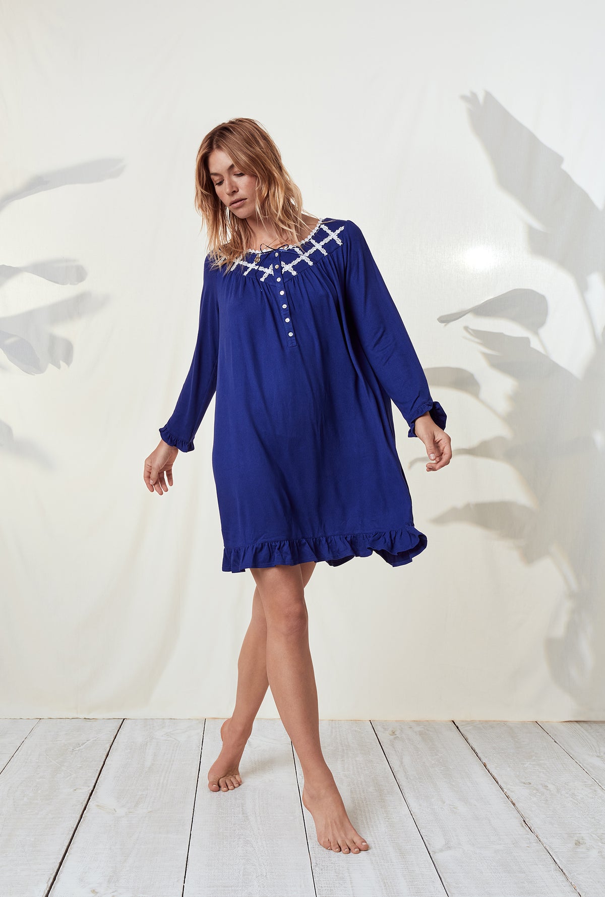 A lady wearing a dream sweater indigo long sleeve knit short nightgown.