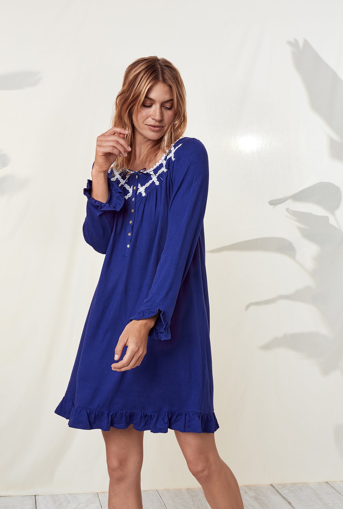 A lady wearing a dream sweater indigo long sleeve knit short nightgown.