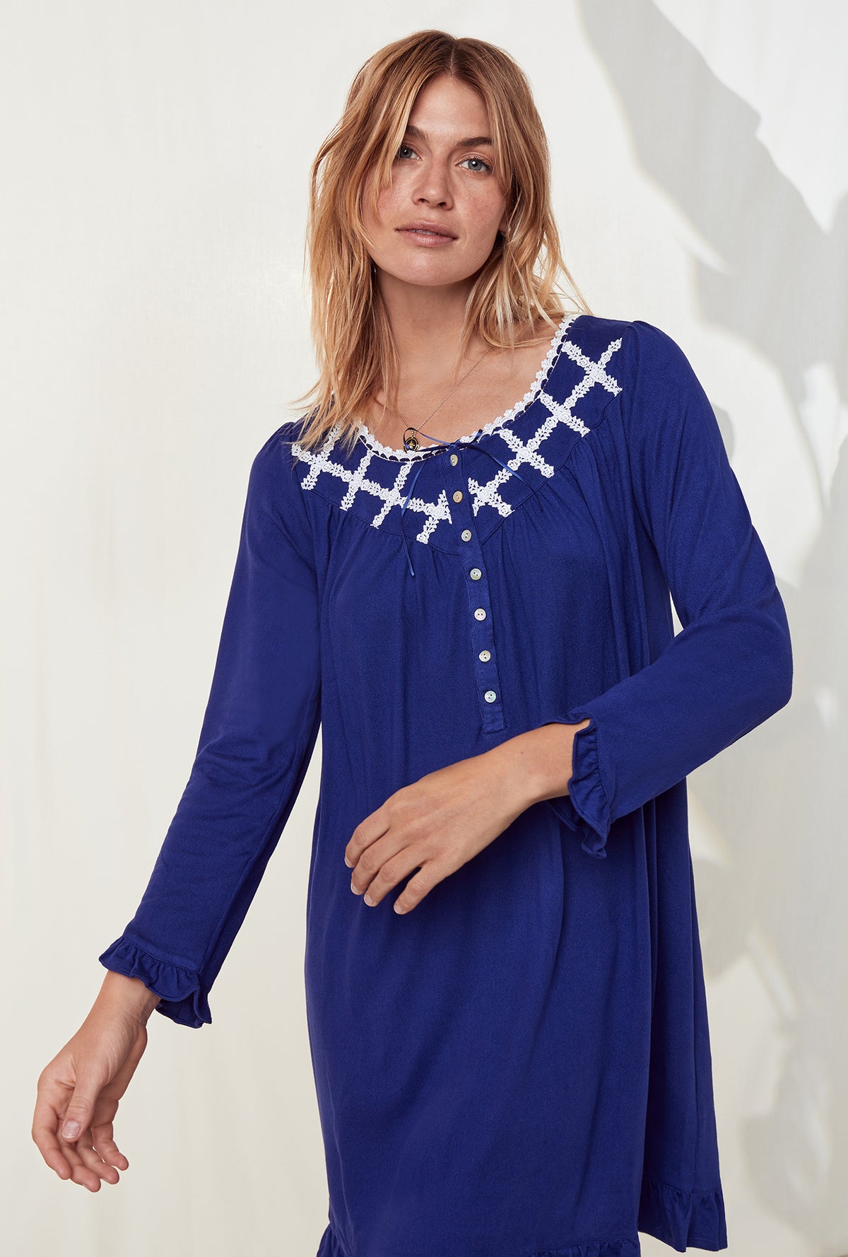 A lady wearing a dream sweater indigo long sleeve knit short nightgown.