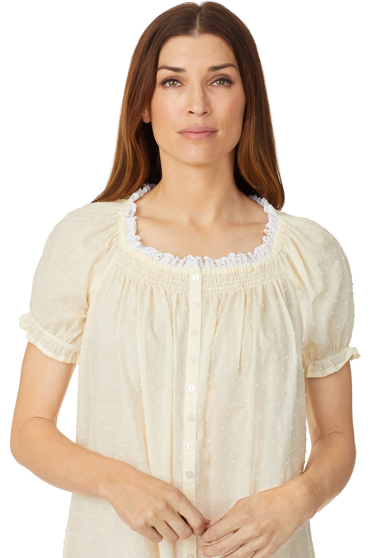 A lady wearing a yellow cap sleeve short nightdress with white dot pattern.