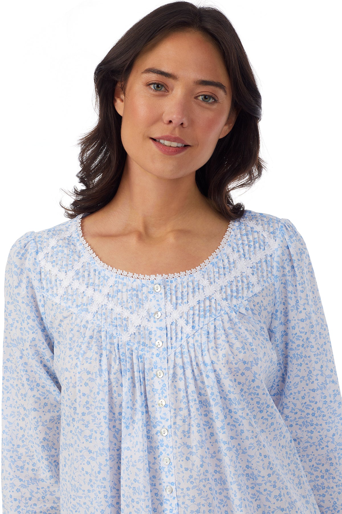 Upper body of A lady wearing white long sleeve nightgown with blue floral design