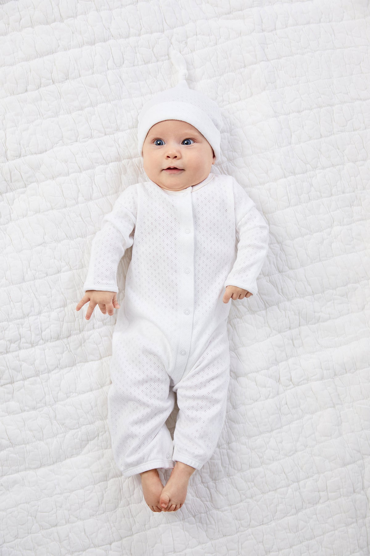 A baby wearing a white dress