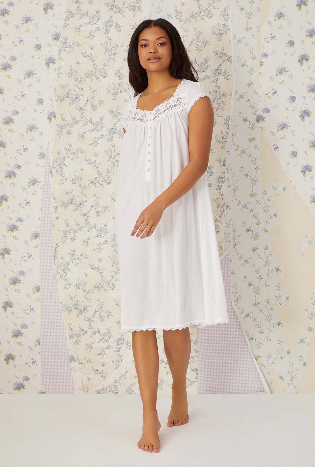 A lady wearing white villa blanca waltz knit nightgown.