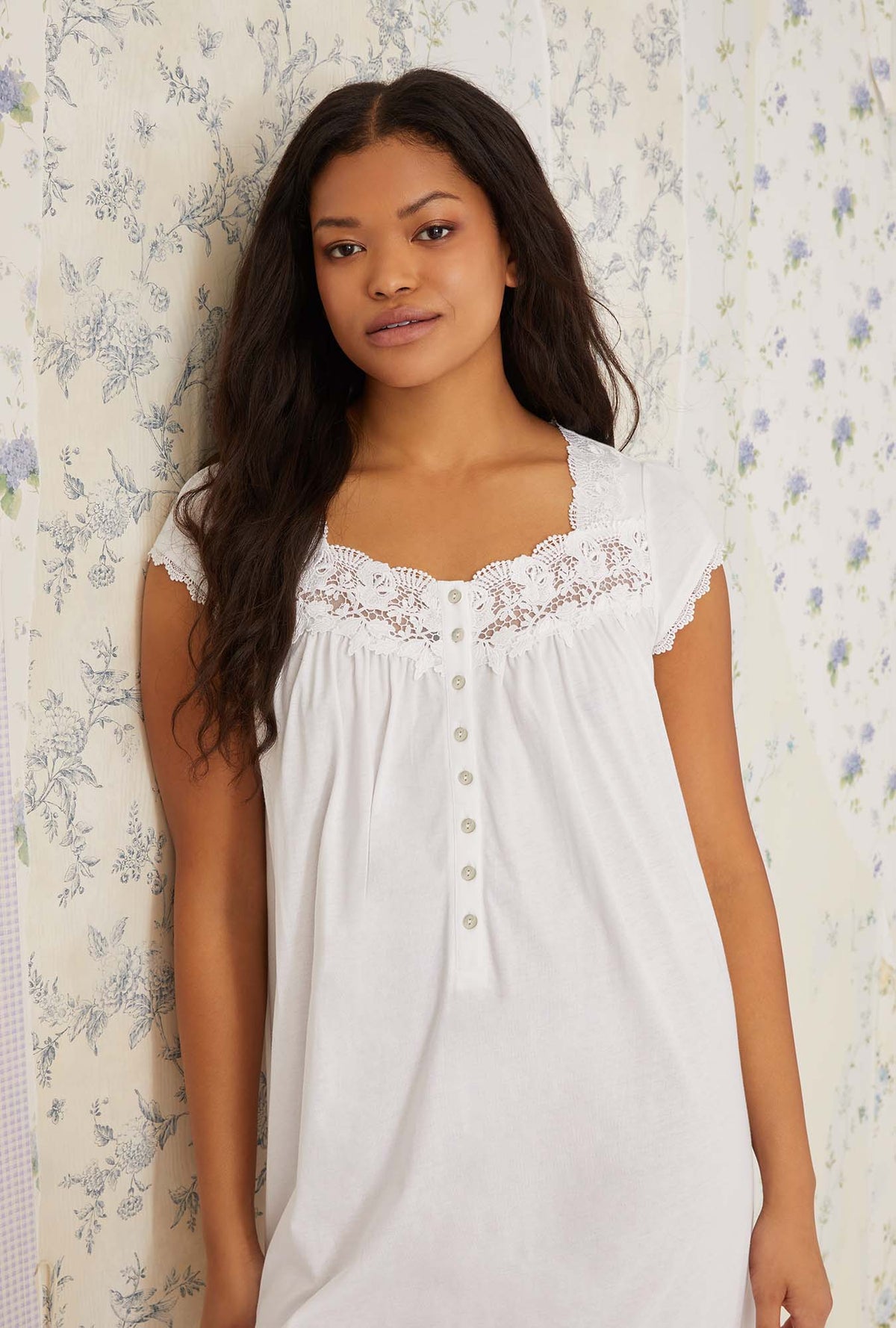 A lady wearing white villa blanca waltz knit nightgown.