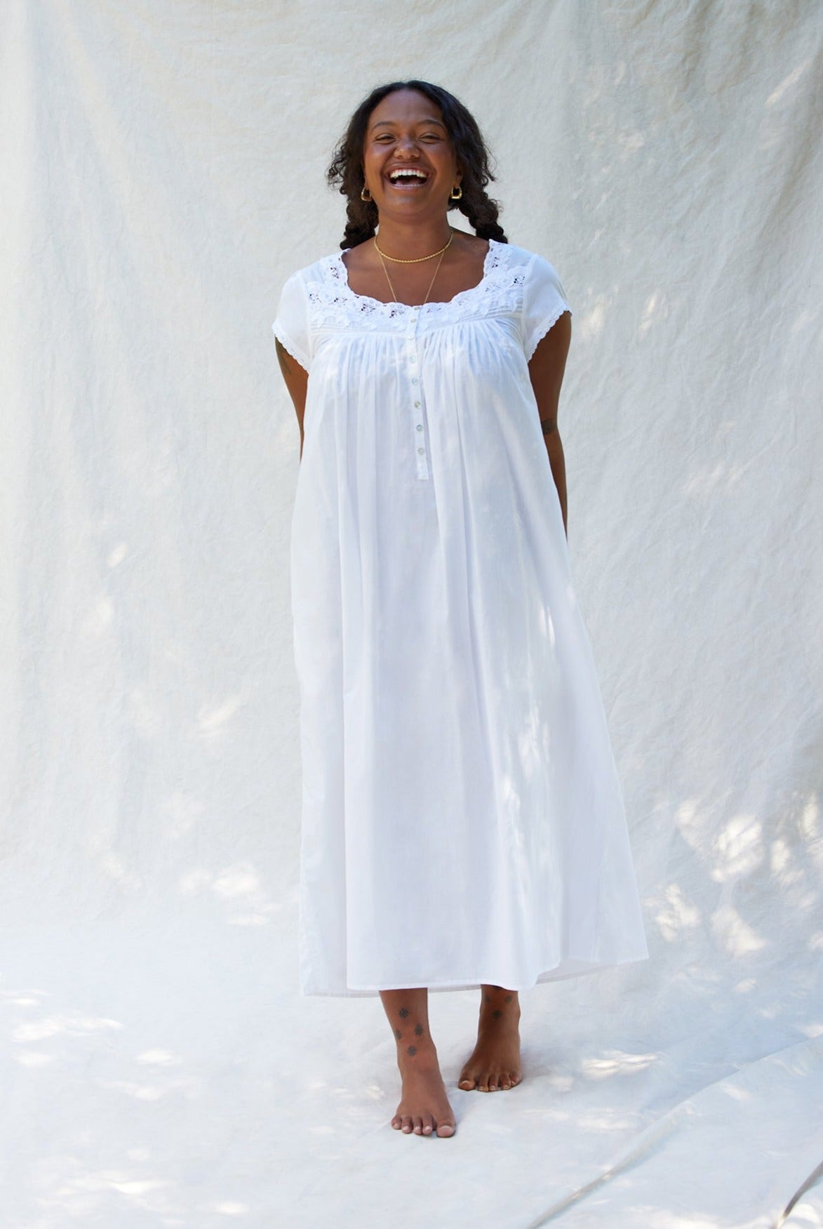 A lady wearing Florentine Lace Cap Sleeve Gown